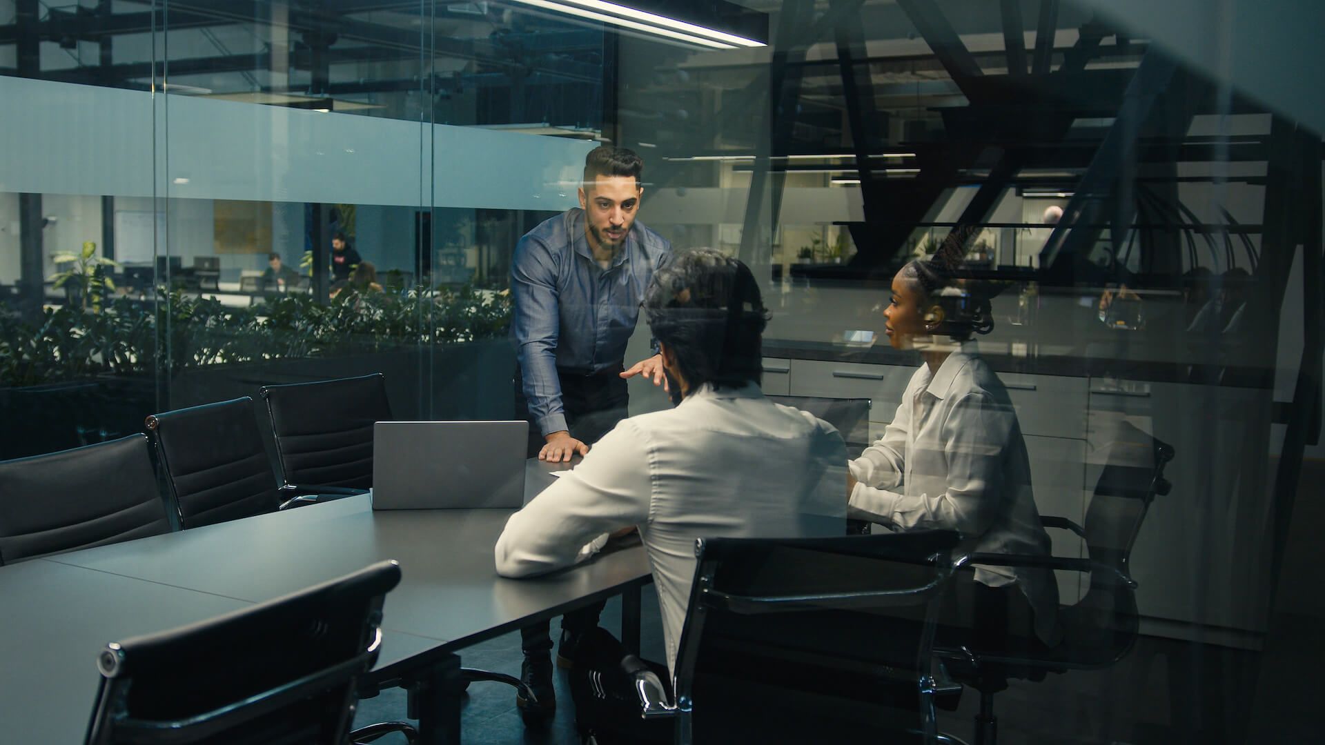 leader company CEO boss leader male business coach man with laptop talk to multiracial colleagues diverse man and woman corporate studying project online service presentation in office
